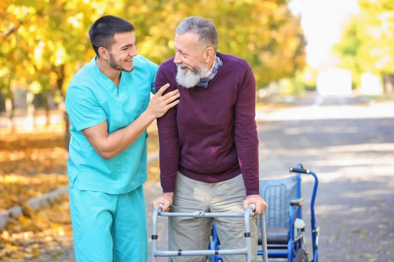Caregiver helping a senior with a walking cane